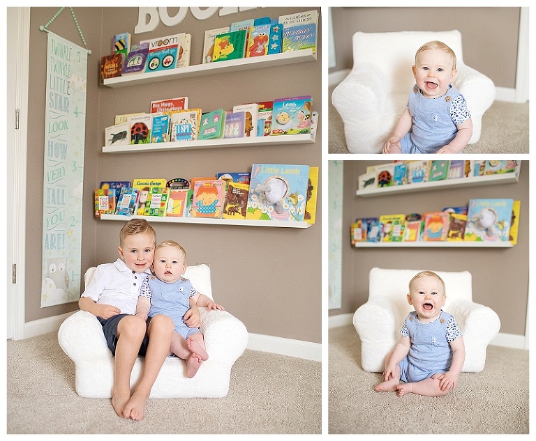 Little boy with his baby brother in the nursery in front of their shelves of books.  Baby is smiling for the photographer.